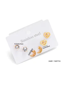 Detailed view of stainless steel earring set featuring CZ studs, heart, and moon stars