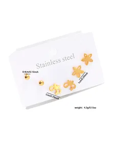Set of three golden stainless steel earrings with ball, flower, and butterfly star motifs