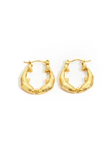 Detailed view of gold fishtail hoop earrings with vertical texture and pin closure