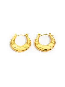 Detail of gold crescent earrings featuring celestial star textures and latch closures