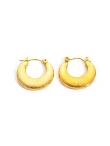 Detailed view of golden hoop earrings featuring concentric circular ripple textures