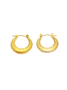 Detailed macro view of vintage gold hoop earrings with a hammered metal texture finish