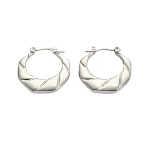 Irregular silver titanium steel hoop earrings with geometric grooves and polished finish