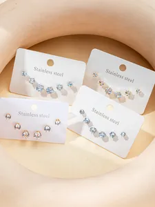 Detailed set of stainless steel stud earrings with zirconia stones in gold and silver