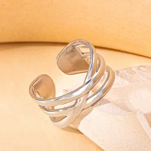 Macro shot of silver woven stainless steel open ring on a stone aesthetic pedestal