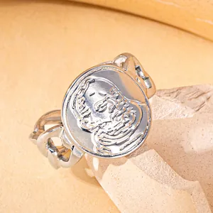 Macro detail of retro silver steel coin ring with portrait relief and chain band