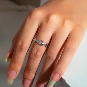 Detailed close-up of a stainless steel chain ring with polished and twisted textures