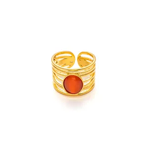 Detailed view of multilayer gold titanium ring with a round orange gemstone and open band
