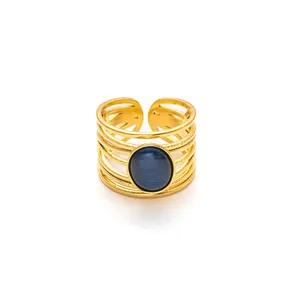 Macro detail of gold multi-layer adjustable ring with blue oval cat-eye gemstone