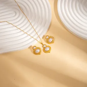 Elegant gold-tone jewelry set with oval pearls and intricate vintage engraving