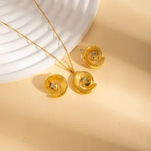 Golden stainless steel jewelry set featuring spiral swirl design with sparkling zircon accents
