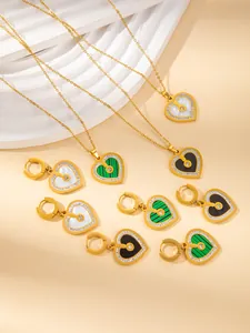 Detail of gold-plated heart necklaces and earrings set with shell and malachite inlays