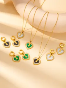 Macro detail of gold plated heart necklace with malachite and zircon pavé inlay