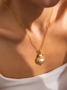 Close-up of a vintage golden bow pearl pendant necklace with elegant 18K gold finish