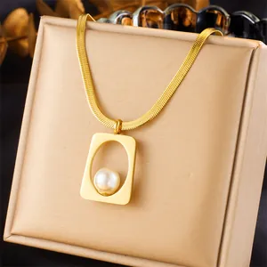 Gold layered snake chain necklace featuring a hollow geometric pendant with a white pearl