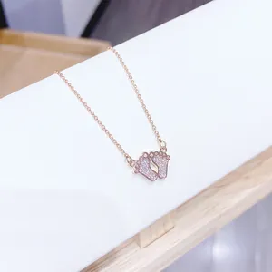 Rose gold necklace with crystal-pave baby footprint pendant on delicate cable chain