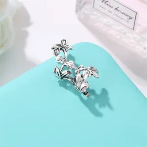 Vintage silver leaf ear cuff with intricate floral patterns and leaf vein details
