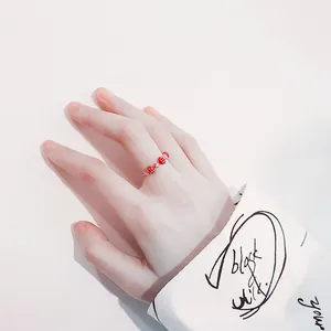 Cute red strawberry silver ring with sparkling accents for women, worn on the index finger