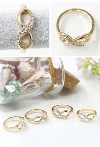 Close-up of infinity symbol ring with inlaid rhinestones on a gold alloy band