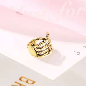 Vintage gold skull hand ring with detailed skeletal bone texture in an adjustable open design