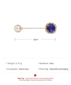 Detailed view of an elegant 6cm safety brooch with blue crystal and white pearl