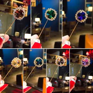 Detailed views of crystal safety pins with various gemstones and faux pearl accents