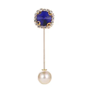 Elegant gold lapel pin with large blue crystal, sparkling rhinestones and white pearl end