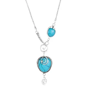 Bohemian style necklace featuring turquoise teardrop pendants and spiral metal accents