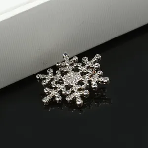 Elegant silver snowflake brooch featuring intricate rhinestone pave setting and crystals