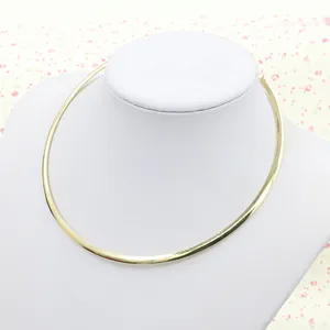 Polished gold punk metal choker necklace displayed on a white neck mannequin stand