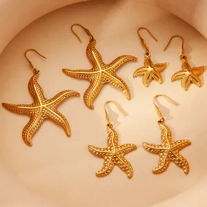Three pairs of gold starfish earrings in various sizes with textured finish and fishhooks