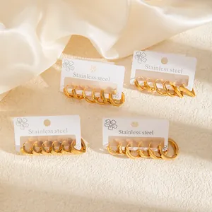 Gold stainless steel hoop earrings set with geometric shapes on floral display cards