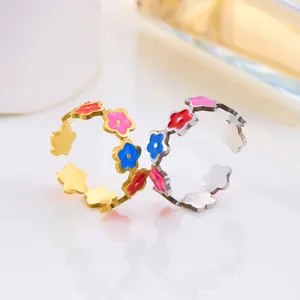 Detalle de anillos florales de esmalte en oro y plata con bandas abiertas ajustables