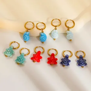 Ocean themed stainless steel hoop earrings set with colorful turtle and conch pendants