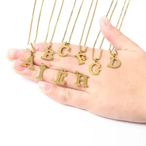 Macro shot of assorted gold initial letter pendants with delicate stainless steel chains