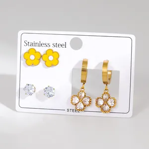 Three-piece stainless steel earring set with yellow floral, zircon, and clover charms