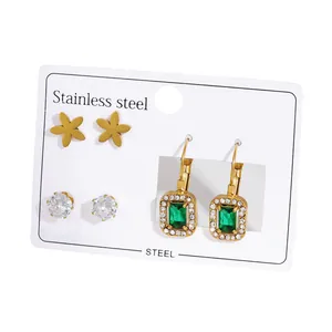 Three-pair stainless steel earring set featuring floral studs and emerald green drops