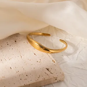 Detail of a vintage 18K gold-plated ginkgo leaf cuff bracelet with a matte brushed finish