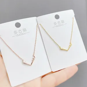 Detail of elegant elk antler pendants in rose gold and gold on jewelry display cards
