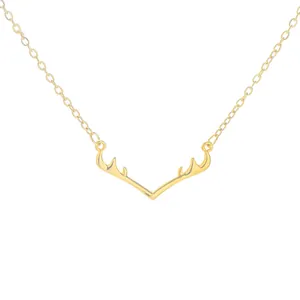 Minimalist golden elk antler pendant necklace with delicate chain on white background