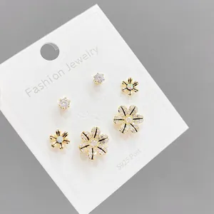 Detail view of s925 silver needle earring set featuring daisy flowers and crystal studs