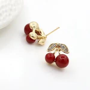Chic cherry stud earrings with gold diamond-encrusted leaves and red resin beads