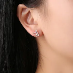 Primo piano di eleganti orecchini a perno con corna di cervo in argento indossati