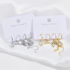 Elegante set de pendientes en oro y plata con corazones de circón y borlas