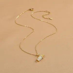 Detail of 925 silver gold-plated necklace with iced tea cup pendant and zircon letter D