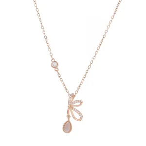 Rose gold bow necklace with opal teardrop pendant and shimmering zircon accents