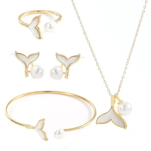 Golden jewelry set with elegant fishtail charms and pearls, necklace rings and earrings