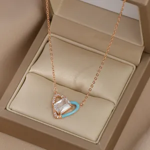 Détail du collier coeur en or rose avec émail bleu et cristal rectangulaire scintillant