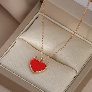 Rose gold clavicle necklace with red devil-heart pendant in a luxury jewelry box