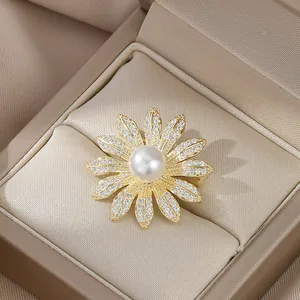 Elegant gold daisy brooch with micro-pave zircons and central pearl on champagne satin